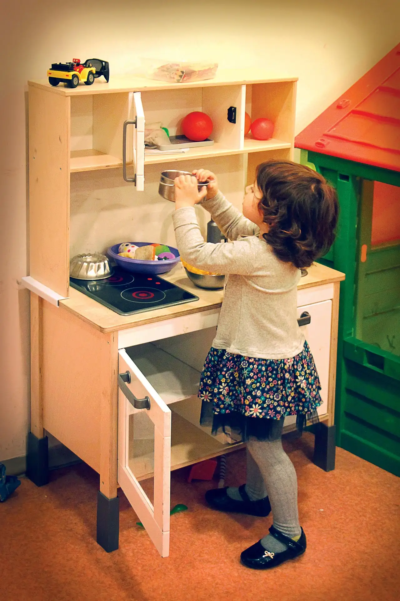 girl with play kitchen